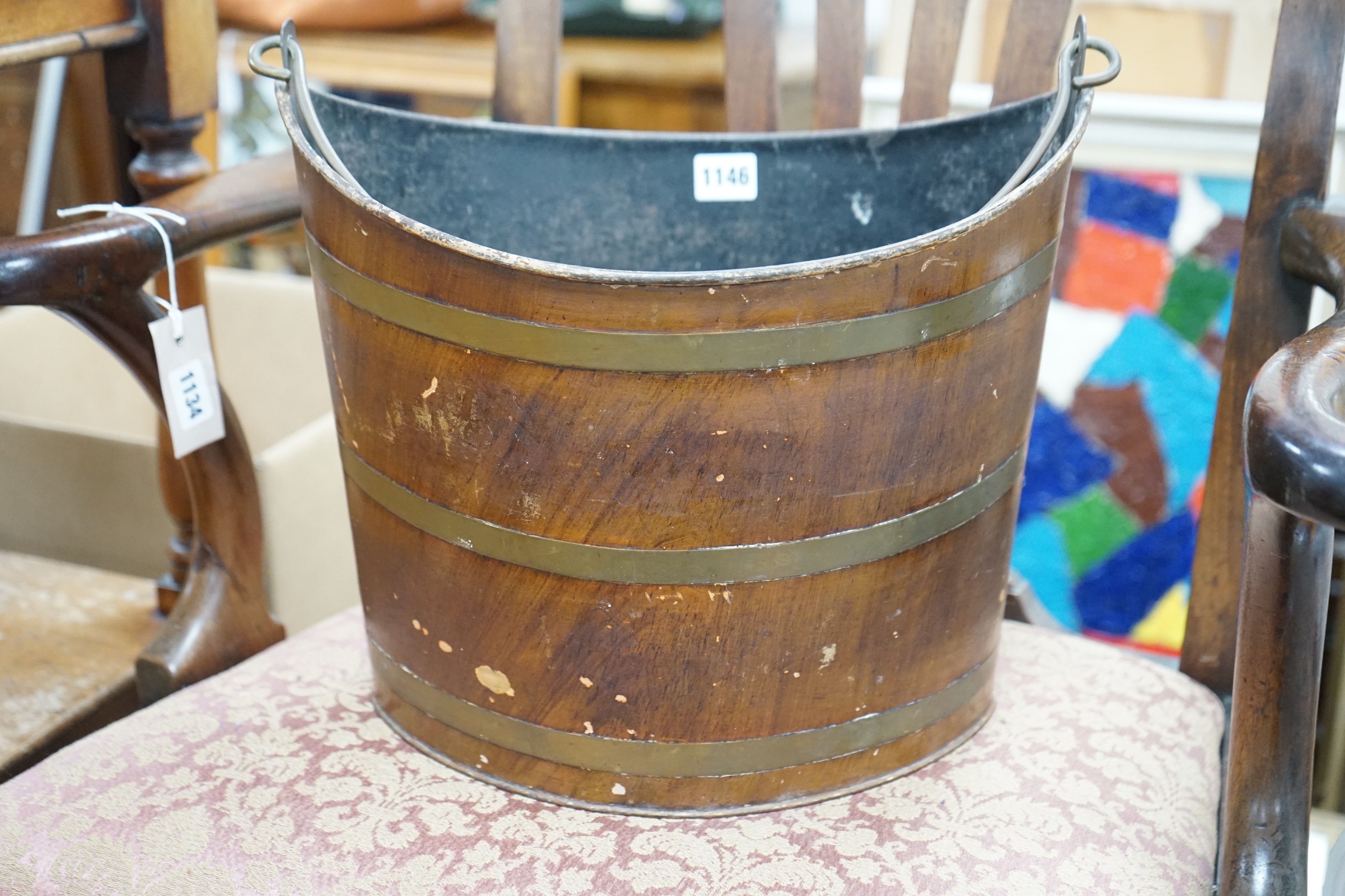 A Regency Toleware bucket with simulated mahogany and brass effect